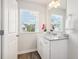 Bright bathroom featuring granite vanity, window view, and contemporary design; creating a spa-like feel at 11837 Rizvan Pl, Covington, GA 30014