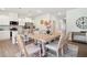 Bright dining area adjacent to a modern kitchen with stainless steel appliances and granite countertops at 11837 Rizvan Pl, Covington, GA 30014