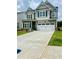 Charming two-story home featuring a symmetrical facade, double garage and well-manicured lawn at 11837 Rizvan Pl, Covington, GA 30014