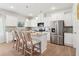 Bright kitchen boasting stainless steel appliances, granite countertops, and a functional island at 11837 Rizvan Pl, Covington, GA 30014