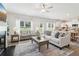 Well-lit living room with a fireplace, stylish decor, and an open view into the adjacent kitchen at 11837 Rizvan Pl, Covington, GA 30014