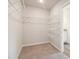 Large walk-in closet with carpeted floors and wire shelving at 11837 Rizvan Pl, Covington, GA 30014