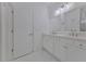 Bright bathroom with a double vanity, modern fixtures and marble floors at 3928 Hester St, Duluth, GA 30097