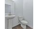 Cozy half bathroom features a pedestal sink and a standard toilet at 3928 Hester St, Duluth, GA 30097