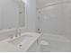 Bright bathroom featuring a tub and shower combination and marble floors at 3928 Hester St, Duluth, GA 30097