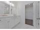 Bathroom featuring double vanity, walk-in closet, and marble floors at 3928 Hester St, Duluth, GA 30097