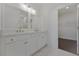 Bathroom featuring double vanity, walk-in closet, and marble floors at 3928 Hester St, Duluth, GA 30097