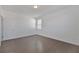 A cozy bedroom features hardwood floors, white walls, and a window with bright sunlight at 3928 Hester St, Duluth, GA 30097