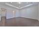 Bright bedroom with trey ceilings and hardwood floors leading to the hallway at 3928 Hester St, Duluth, GA 30097