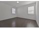 A sunny bedroom boasts hardwood floors, white walls, and large windows with natural light at 3928 Hester St, Duluth, GA 30097