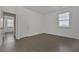 A modern bedroom with hardwood floors, white walls, and a window for natural light at 3928 Hester St, Duluth, GA 30097