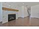 Modern fireplace featuring marble tile and hardwood mantel in a brightly lit, open floorplan home at 3928 Hester St, Duluth, GA 30097