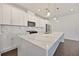 Modern kitchen featuring white cabinets, quartz countertops, a large island, and stainless steel appliances at 3928 Hester St, Duluth, GA 30097