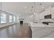 Bright living room with a marble fireplace, hardwood floors, and an open concept kitchen at 3928 Hester St, Duluth, GA 30097