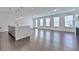 Open concept living area with hardwood floors, modern lighting, and large windows at 3928 Hester St, Duluth, GA 30097