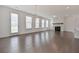 Spacious living room featuring hardwood floors, a modern fireplace, and a contemporary lighting fixture at 3928 Hester St, Duluth, GA 30097