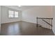 Bright living room with hardwood floors, staircase and natural light from the large window at 3928 Hester St, Duluth, GA 30097