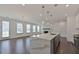 Open floorplan with kitchen island, living room fireplace, and large windows for natural light, in a modern home at 3928 Hester St, Duluth, GA 30097