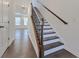 Staircase with hardwood floors and wrought iron balusters at 3928 Hester St, Duluth, GA 30097