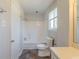 White bathroom featuring a bathtub and shower combo, toilet and vanity with granite floors at 6050 Randy Ln, Ellenwood, GA 30294