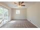 Bright bedroom with a ceiling fan and a sliding glass door leading to the outside at 6050 Randy Ln, Ellenwood, GA 30294