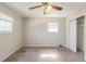 Bedroom with ceiling fan and closet space, featuring carpet floors and large windows at 6050 Randy Ln, Ellenwood, GA 30294