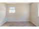 Empty bedroom featuring a large window and plush carpet at 6050 Randy Ln, Ellenwood, GA 30294