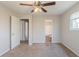 Bedroom with ceiling fan featuring carpeted floors and bright natural light at 6050 Randy Ln, Ellenwood, GA 30294