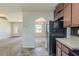 Bright kitchen next to the living room featuring stone floors and wood cabinets at 6050 Randy Ln, Ellenwood, GA 30294