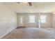 Open living room featuring new carpet, a bright window, and fresh paint at 6050 Randy Ln, Ellenwood, GA 30294