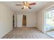 Cozy living room with carpet, ceiling fan, an adjacent staircase and sliding door at 6050 Randy Ln, Ellenwood, GA 30294