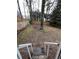 Fenced backyard with some grass and mature trees at 1672 Cedar Bluff Way, Marietta, GA 30062