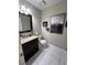 Well-lit powder room features tile flooring, granite countertop and modern decor at 1672 Cedar Bluff Way, Marietta, GA 30062