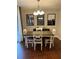 Elegant dining room featuring dark wood floors, modern light fixture, and stylish wall art at 1672 Cedar Bluff Way, Marietta, GA 30062