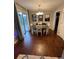 Bright dining room features wood floors, white chairs, and glass doors leading to the yard at 1672 Cedar Bluff Way, Marietta, GA 30062