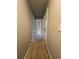 Hallway with carpeted floors and neutral paint, with multiple doors at 1672 Cedar Bluff Way, Marietta, GA 30062