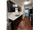 Well-appointed kitchen featuring dark cabinets, stainless appliances, and tile backsplash at 1672 Cedar Bluff Way, Marietta, GA 30062
