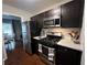 Kitchen with stainless steel appliances, dark wood cabinets, and updated countertops at 1672 Cedar Bluff Way, Marietta, GA 30062