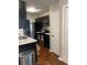 Modern kitchen featuring stainless steel appliances, dark cabinets, and stone countertops at 1672 Cedar Bluff Way, Marietta, GA 30062