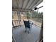 Relaxing screened porch features a wooden rocking chair with backyard views at 1672 Cedar Bluff Way, Marietta, GA 30062