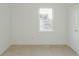 Neutral bedroom featuring a bright window and plush carpeting at 297 Graison Ln, Dallas, GA 30157