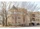 Multi-story building with brick facade, balconies, and mature trees at 423 Georgia Se Ave # 301, Atlanta, GA 30312