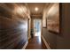 Long hallway featuring hardwood flooring and wall art, leading to a room with a desk and chair at 423 Georgia Se Ave # 301, Atlanta, GA 30312