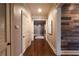 Long hallway with dark wood floors, white doors, unique wood plank accent wall, and recessed lighting at 423 Georgia Se Ave # 301, Atlanta, GA 30312