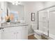 Bright bathroom featuring granite countertops, white cabinetry, and a glass-enclosed shower at 11102 Suria Dr, Conyers, GA 30014