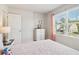 Relaxing bedroom with a large window offering neighborhood views and a classic dresser at 11102 Suria Dr, Covington, GA 30014