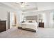 Spacious main bedroom with a tray ceiling, plush carpet, and ensuite bathroom access at 11102 Suria Dr, Covington, GA 30014