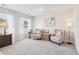 Cozy sitting area featuring natural light from sheer curtains and neutral-toned furniture at 11102 Suria Dr, Conyers, GA 30014