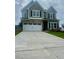 Charming two-story home featuring a two-car garage, brick accents, and well-manicured lawn at 11102 Suria Dr, Covington, GA 30014