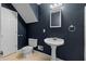 A contemporary bathroom features a pedestal sink and a white toilet at 115 Louise Ln, Villa Rica, GA 30180